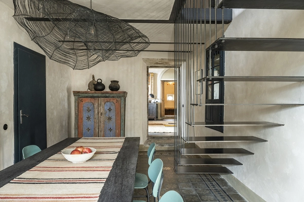 Harmonious: Modern staircase (and lamp) between old stone walls.