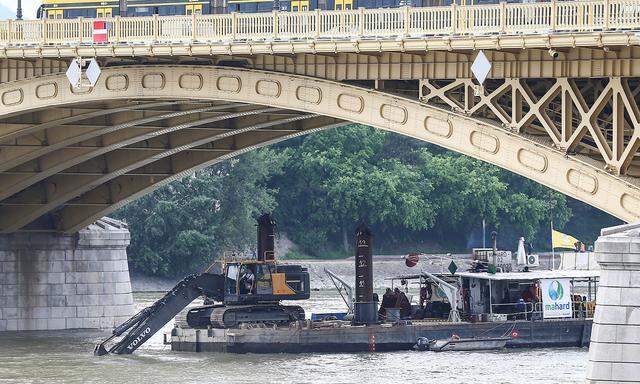 A dredge is seen digging near the site of a tourist boat accident in the Danube river in Budapest