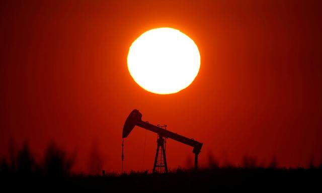 FILE PHOTO: The sun sets behind a pump-jack outside Saint-Fiacre