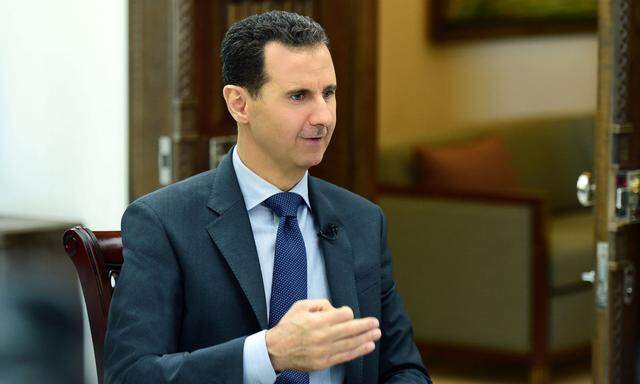 Syria's President Bashar al-Assad speaks during an interview with RIA Novosti and Sputnik