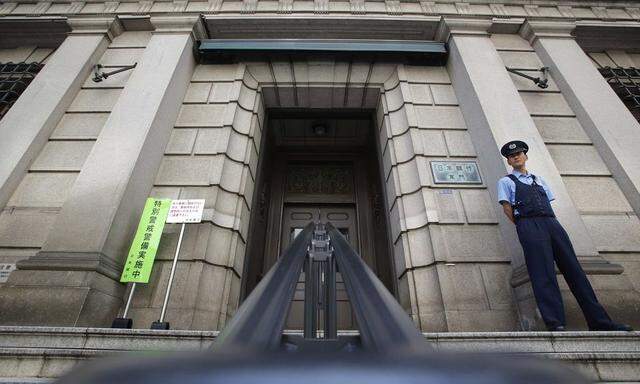 A security personnel stands guard at the Bank of Japan building in Tokyo
