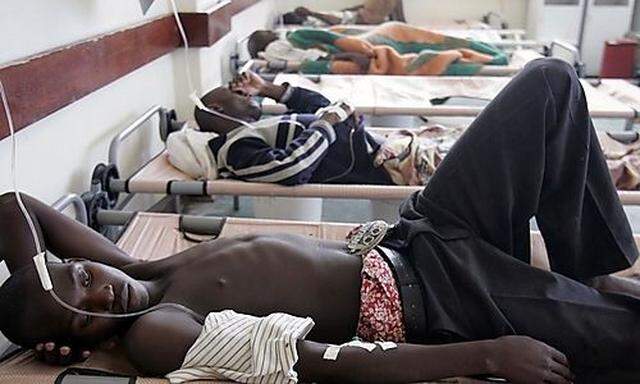 Cholera patients rest on their beds inside the male ward of Budiriro Polyclinic in Harare