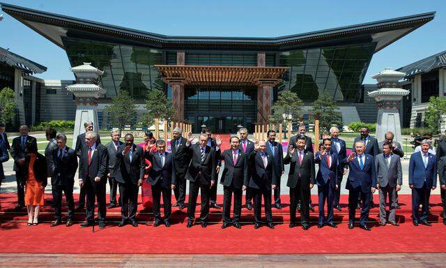 Leaders attending the Belt and Road Forum wave as they pose for a group photo at the Yanqi Lake venue on the outskirt of Beijing
