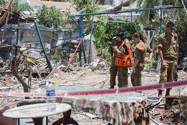 Zerstörungen gibt es auch auf der anderen Seite: Israelische Soldaten inspzieren ein von einer Hamas-Rakete getroffenes Haus in Yahud südlich von Tel Aviv.