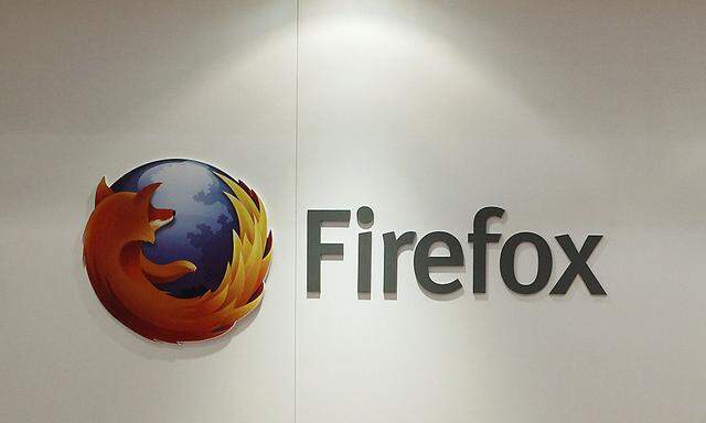 A man is seen next to a Firefox logo at a Mozilla stand during the Mobile World Congress in Barcelona