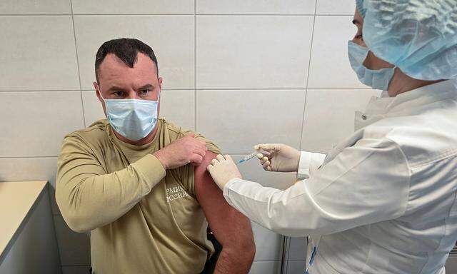 FILE PHOTO: A Russian Army service member receives an injection with Sputnik V (Gam-COVID-Vac) vaccine against the coronavirus disease (COVID-19) at a clinic in the city of Rostov-On-Don