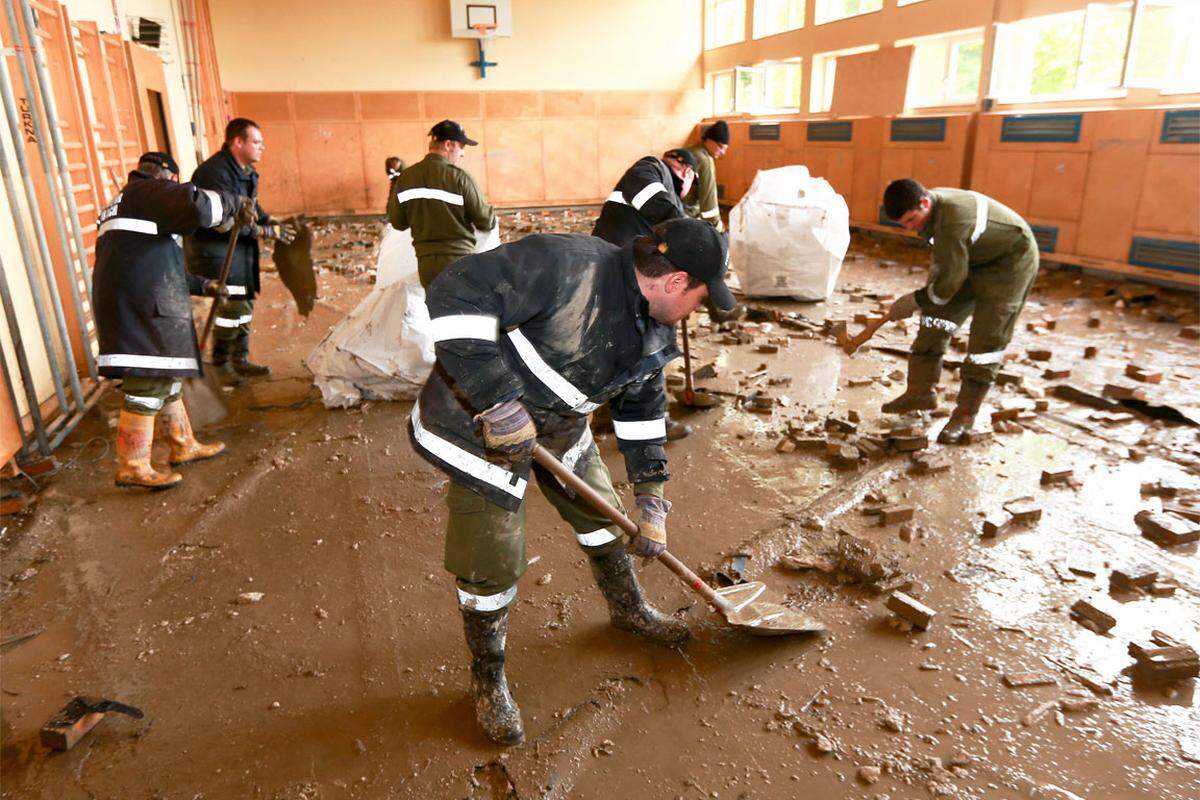 Kaum zu erkennen, dass es sich hier um einen Turnsaal handelt: Kräfte der Feuerwehr bei Aufräumarbeiten im Kindergarten in Hochburg Ach bei Braunau