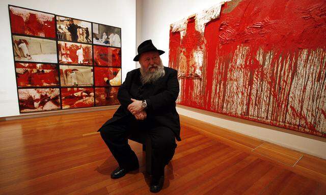 Austrian-born artist Nitsch poses at his retrospective ´Theatre of Orgies and Mysteries´ at Berlin´s Martin-Gropius-Bart art gallery