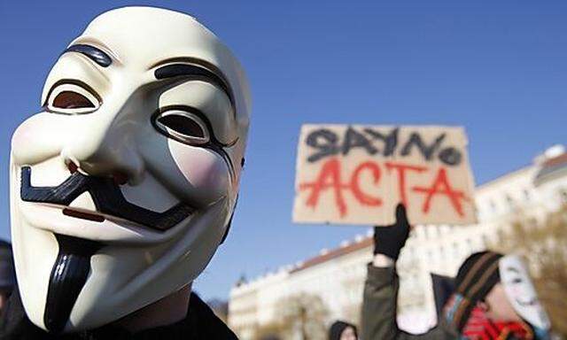 A protester wearing a Guy Fawkes mask attends a demonstration against the Anti-Counterfeiting Trade A
