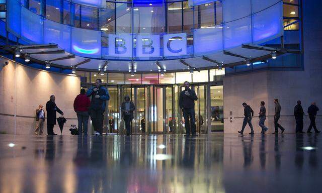 People arrive at, and leave, the BBC headquarters at New Broadcasting House in central London