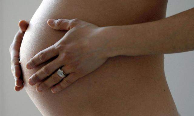 FILE PHOTO: A pregnant woman, in the last trimester of her pregnancy, poses in this illustration photo in Sete