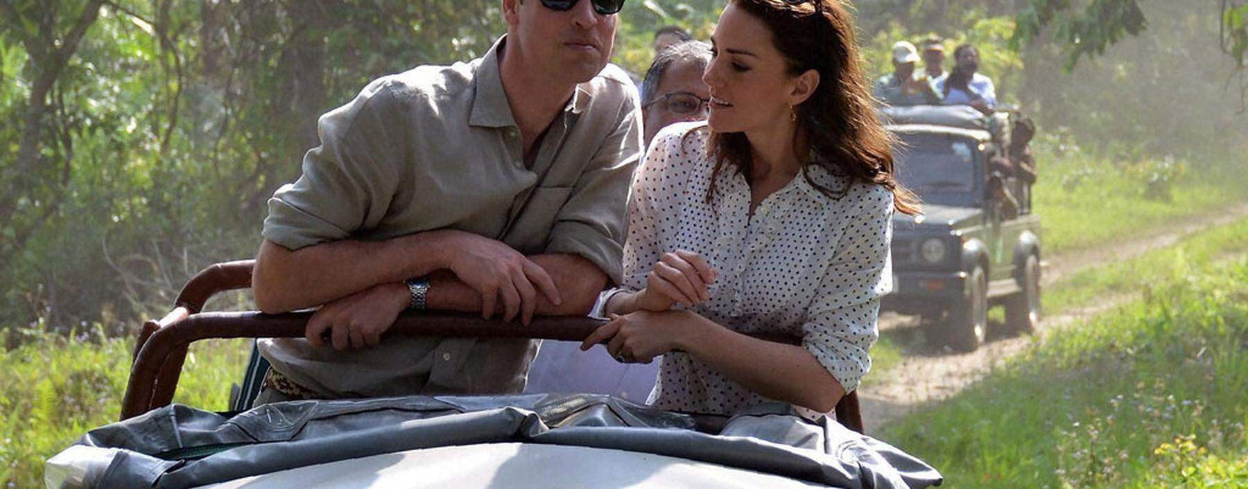 Britain's Prince William and his wife Catherine, the Duchess of Cambridge, feed baby elephants at the CWRC at Panbari reserve forest in Kaziranga