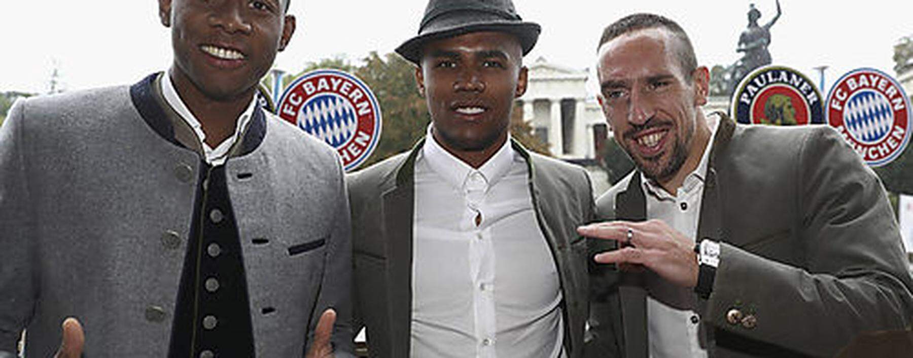 Alaba, Costa, and Ribery of FC Bayern Munich pose during their visit at the Oktoberfest in Munich