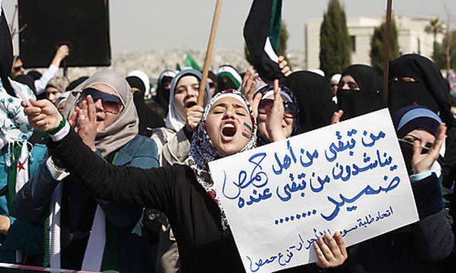 Syrian women chant anti-Bashar Assad slogans at a protest in front of the Syrian embassy, in Amman, J