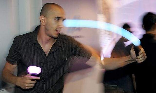 A man tries out the new PlayStation Move controller during E3 Expo in Los Angeles