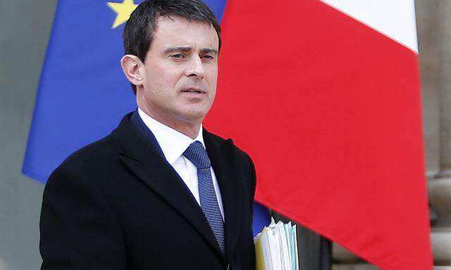 French Interior Minister Manuel Valls leaves following the weekly cabinet meeting at the Elysee Palace in Paris