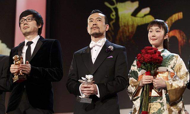 Actor Liao Fan actress Kuroki and director Diao Yinan pose with their prizes during awards ceremony of 64th Berlinale International Film Festival in Berlin