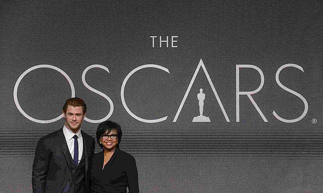 Actor Chris Hemsworth and Academy of Motion Picture Arts and Sciences President Cheryl Boone Isaacs pose for photographers after the 86th Academy Awards nominee announcements in Beverly Hills