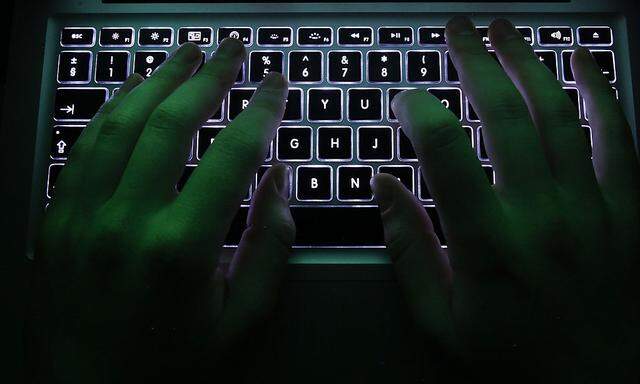 Illustration file picture shows a man typing on a computer keyboard in Warsaw