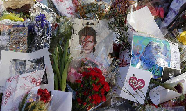 Tributes to the late British singer David Bowie are seen at a makeshift memorial outside his home in the Manhattan borough of New York City