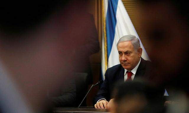Israeli PM Netanyahu looks on during his Likud party faction meeting at the Knesset in Jerusalem