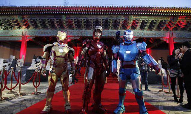 File picture of performers posing during a promotional event of the movie ´Iron Man 3´ at the Imperial Ancestral Temple of Beijing´s Forbidden City