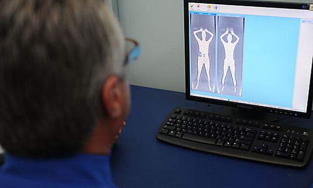 TSA officer Richard Simons, shows what officers see from a full body scan at the Los Angeles Internat