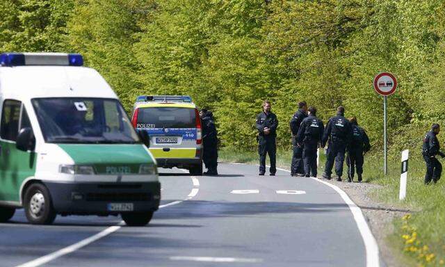 Police conduct a search of a forest area just outside the town of Oberursel near Frankfurt,