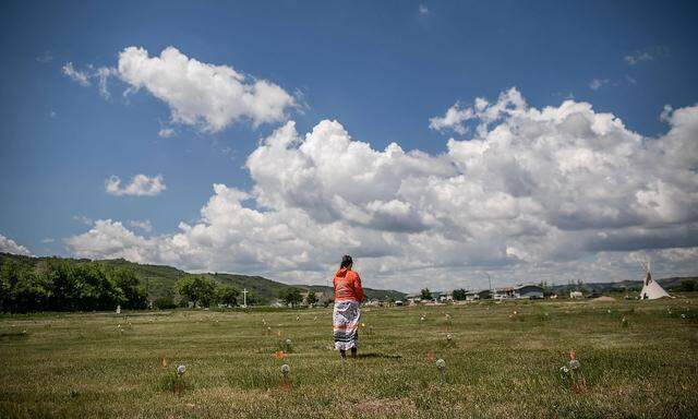 (210627) -- SASKATCHEWAN (CANADA), June 27, 2021 -- A member of the Cowessess First Nation stands at the site of unmarke