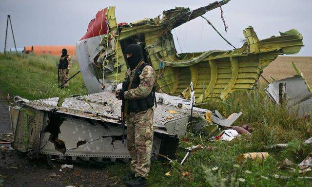 ITAR TASS DONETSK REGION UKRAINE JULY 18 2014 Donbass militants cordon off the crash site of a