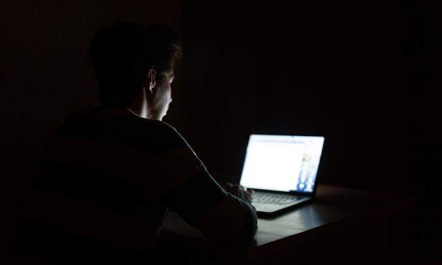 Man Using Mobile Phone In Darkroom