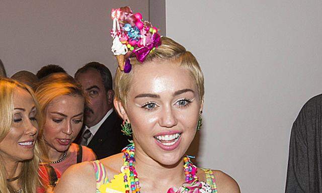 Singer Miley Cyrus arrives to attend a presentation of the Jeremy Scott Spring/Summer 2015 collection during New York Fashion Week