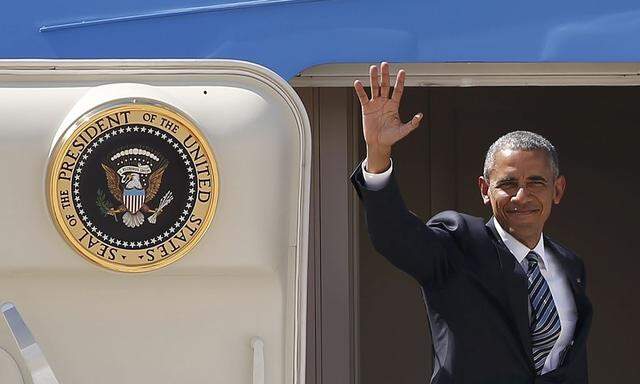 U.S President Obama waves as he boards Air Force One at the Torrejon airbase, outside Madrid