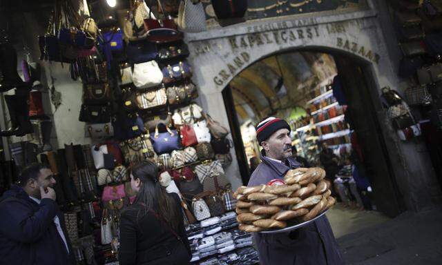 A street vendor sells traditional Turkish bagels, simit, outside the historical Grand Bazaar, known as the Covered Bazaar, in Istanbul