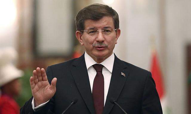 Turkey's Prime Minister Davutoglu speaks at a news conference with Iraqi Prime Minister Haider al-Abadi in Baghdad