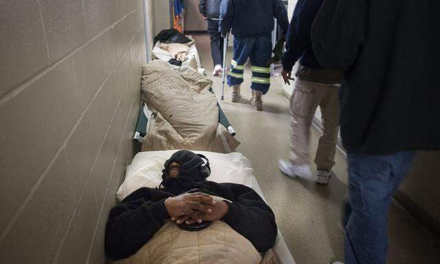 Myron Jackson sleeps on a cot in the hallway at the Atlanta Mission homeless shelter, after their rooms reached their capacity, in downtown Atlanta, Georgia