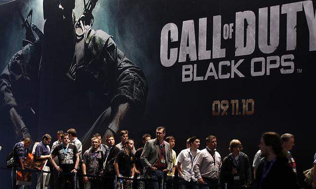 Visitors wait at an exhibition stand for ´Call of Duty - Black Ops´ at the Gamescom 2010 fair in Cologne