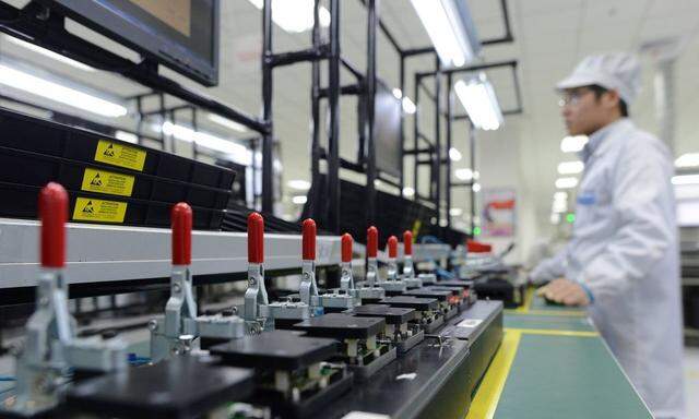 Employees work on the production line of smart phone at the