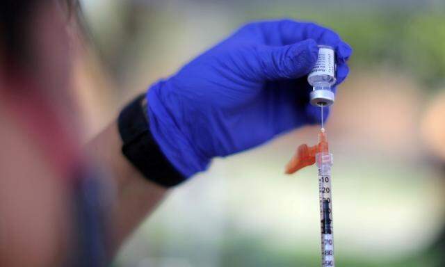 FILE PHOTO: A nurse prepares a Pfizer BioNTech coronavirus disease (COVID-19) vaccination as part of a vaccine drive by the Fernandeno Tataviam Band of Mission Indians in Arleta, Los Angeles