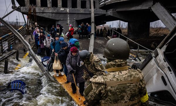 Nichts wie raus aus Irpin. Nur mit den allernötigsten Habseligkeiten machten sich die Menschen im März über eine zerstörte Brücke auf den Weg aus einer der Vorstädte Kiews.