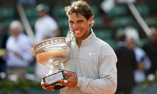 Rafael Nadal of Spain poses with the trophy during the ceremony after defeating Novak Djokovic of Serbia during their men's singles final match to win the French Open Tennis tournament in Paris