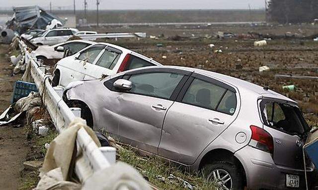 Damaged cars are seen at an area that was devastated by the March 11 earthquake and tsunami, in Watar