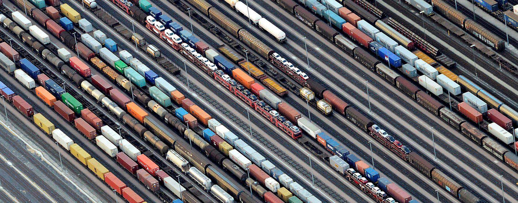 Containers and cars are loaded on freight trains at the railroad shunting yard in Maschen near Hamburg