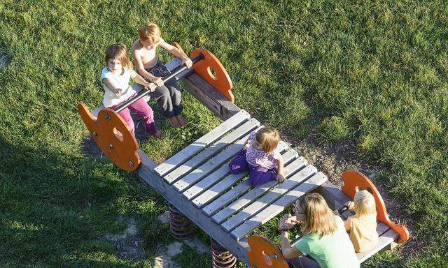 kids at swing at playground in Neulengbach Wienerwald Vienna Woods Nieder�sterreich Lower Austri