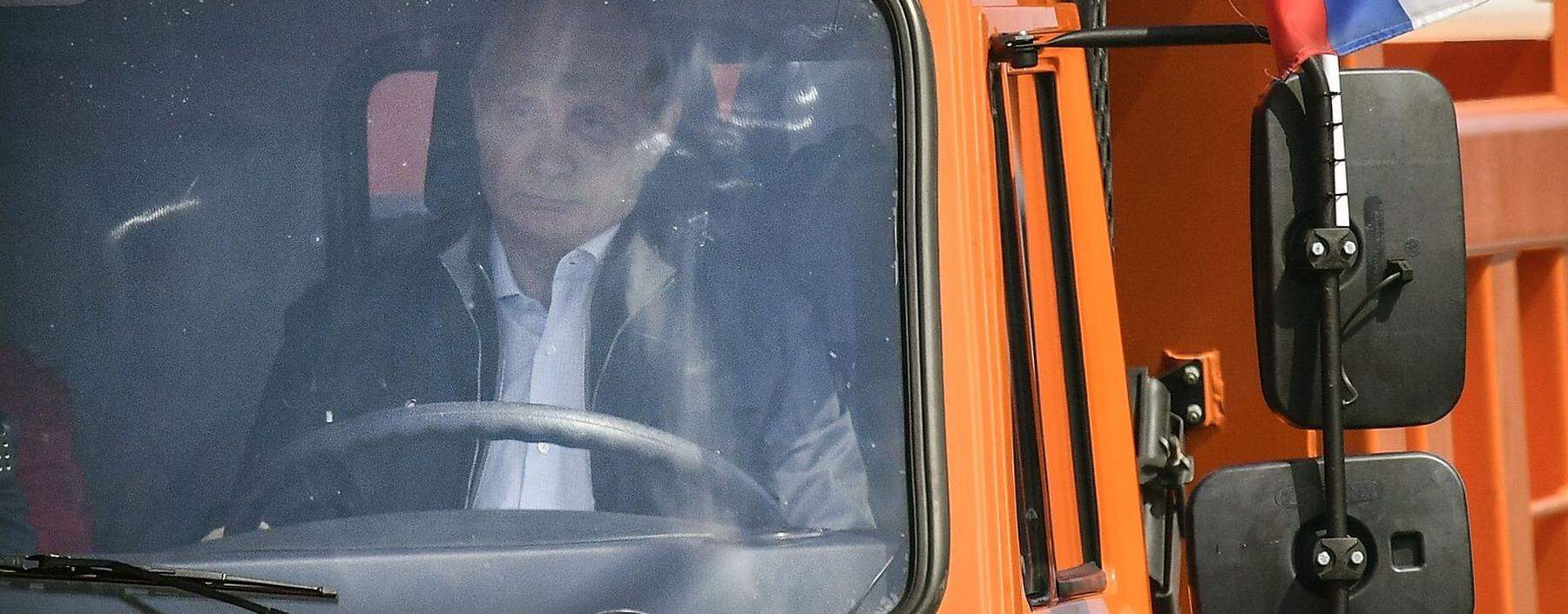 Russian President Putin drives a Kamaz truck during a ceremony opening a bridge, which was constructed to connect the Russian mainland with the Crimean Peninsula across the Kerch Strait