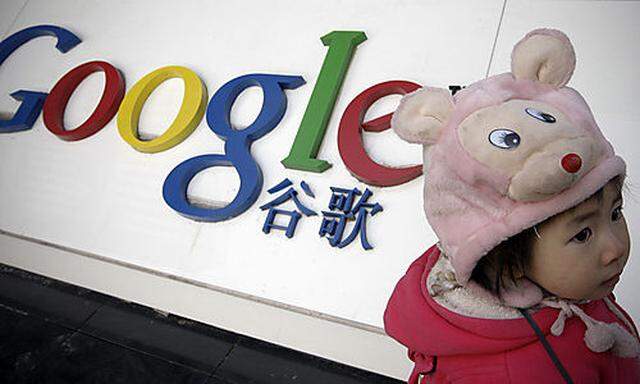 Xiao Jing, a 2-years-old Chinese girl from Chengdu, stands in front of the Google logo outside the Go