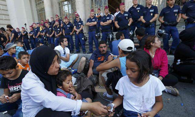 Hungarian police officers block the entrance of the Keleti train station for refugees in Budapest