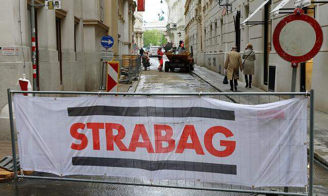 The logo of Austrian construction firm Strabag is seen on the fence blocking a road in Vienna
