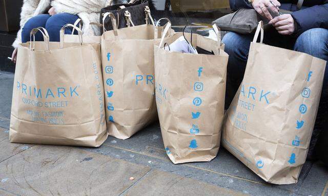 Busy day on Oxford Street in the run up to Christmas London UK Shoppers with shopping bags from Pr