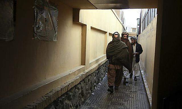 Former Taliban militants are seen following a ceremony to mark their reconciliation with the Afghan g